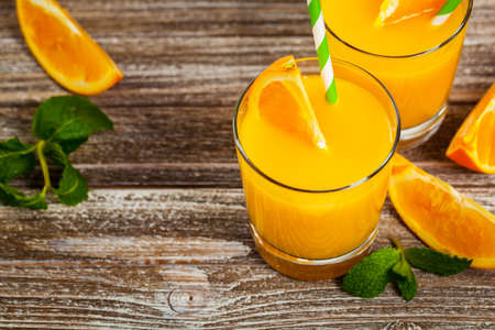 Orange Juice on Wooden Background. Selective focus.の写真素材
