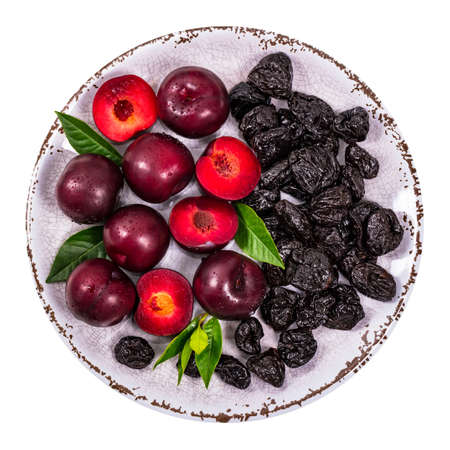 Fresh Plums and Dried Pitted Prunes Isolated on a white background. Selective focus.の写真素材