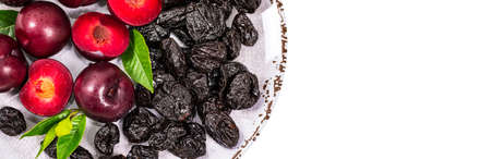 Fresh Plums and Dried Pitted Prunes Isolated on a white background. Selective focus.の写真素材