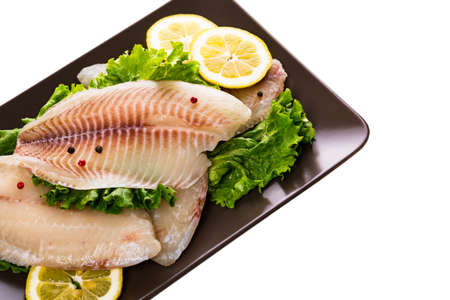 Whitefish Tilapia Fish Raw Fillet Isolated on White. Selective focus.の写真素材