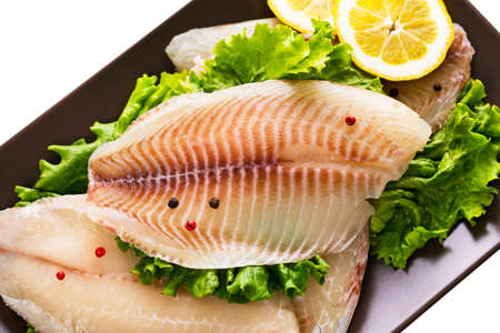 Whitefish Tilapia Fish Raw Fillet Isolated on White. Selective focus.の写真素材