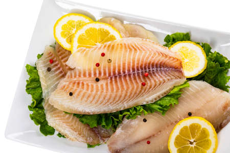 Whitefish Tilapia Fish Raw Fillet Isolated on White. Selective focus.の写真素材