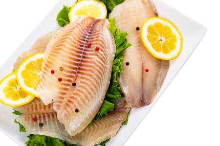 Whitefish Tilapia Fish Raw Fillet Isolated on White. Selective focus.の写真素材