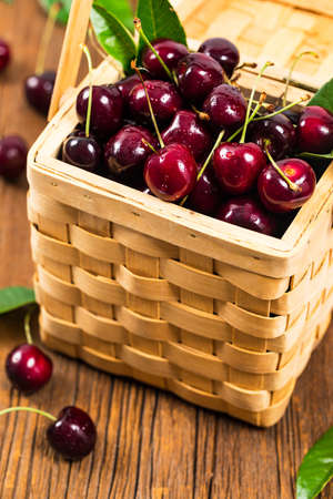 Cherries in a Wicker Basket Background. Selective focus.の写真素材