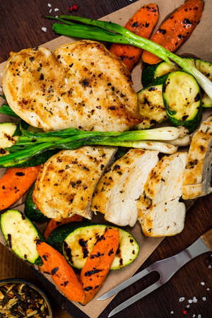 Grilled Chicken Breasts with Grilled Vegetables Zucchini and Carrot Background. Selective focus.の写真素材