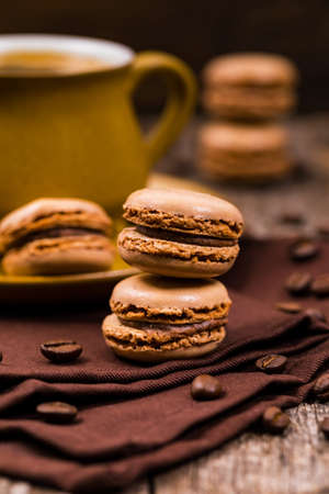 Chocolate Macaron with Coffee Beans on Wooden Table. Selective focus.の写真素材