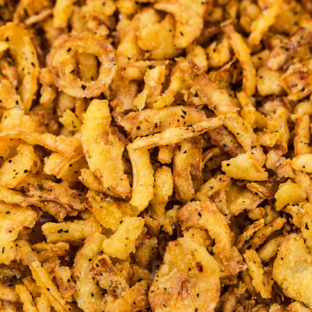 Crispy Fried Onion Strings with Garlic and Pepper. Selective focus.の写真素材