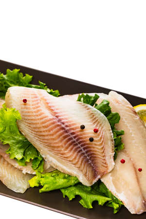 Whitefish Tilapia Fish Raw Fillet Isolated on White Background. Selective focus.の写真素材