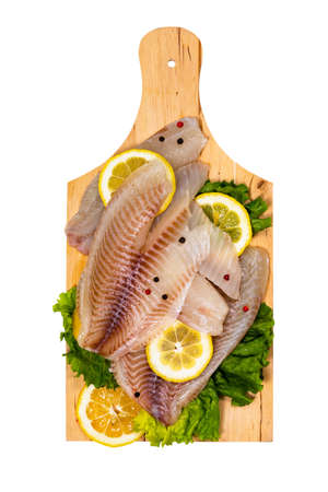 Whitefish Tilapia Fish Raw Fillet Isolated on White Background. Selective focus.の写真素材