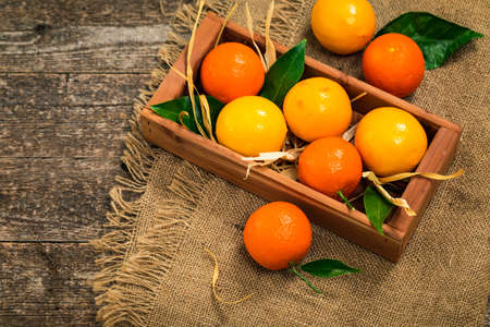 Mandarin Orange or Tangerines on wooden background. Selective focus.の写真素材