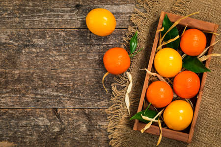 Mandarin Orange or Tangerines on wooden background. Selective focus.の写真素材