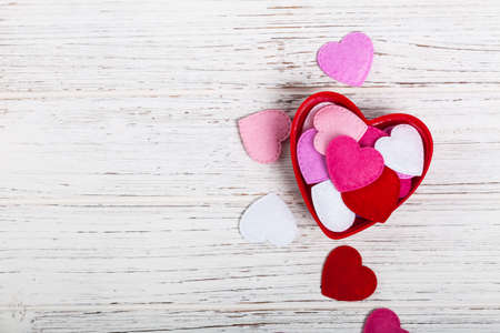Valentines Day Background with Fabric Toy Hearts over Wooden Background. Selective focus.の写真素材
