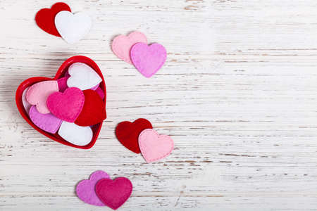 Valentines Day Background with Fabric Toy Hearts over Wooden Background. Selective focus.の写真素材