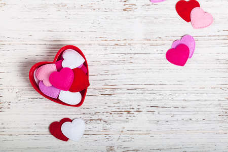Valentines Day Background with Fabric Toy Hearts over Wooden Background. Selective focus.の写真素材