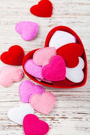 Valentines Day Background Card with Fabric Hearts over Wooden Background. Selective focus.の写真素材