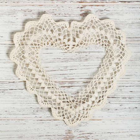 Valentines day background with Crochet Heart over white wooden table. Selective focus.の写真素材