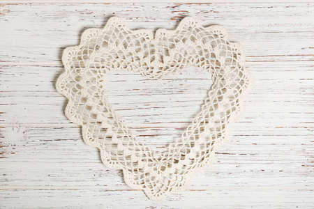 Valentines day background with Crochet Heart over white wooden table. Selective focus.の写真素材