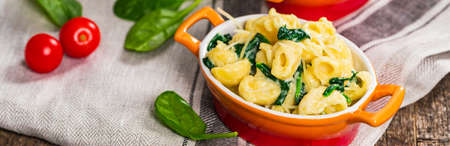 Spinach Mac and Cheese on Wooden Background. Selective focus.の写真素材