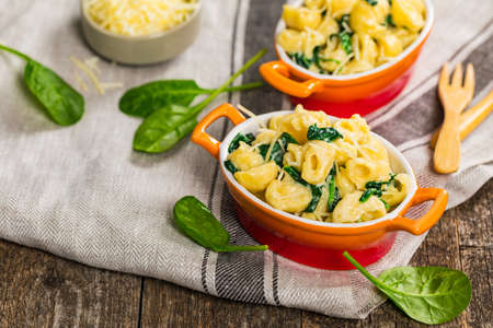Spinach Mac and Cheese on Wooden Background. Selective focus.の写真素材