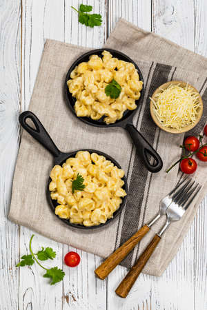 Cast Iron Mac and Cheese on White Wooden Background. Selective focus.の写真素材