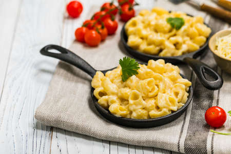 Cast Iron Mac and Cheese on White Wooden Background. Selective focus.の写真素材