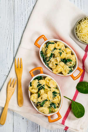Parmesan Spinach Mac and Cheese on White Wooden Background. Selective focus.の写真素材