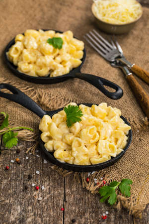 Macaroni and Cheese Old Fashioned Skillet on Wooden Background. Selective focus.の写真素材