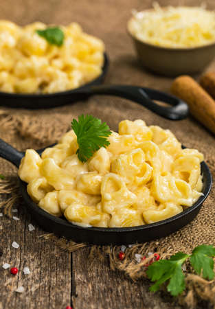 Macaroni and Cheese Old Fashioned Skillet on Wooden Background. Selective focus.の写真素材