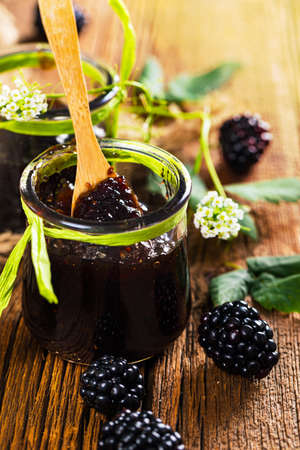 Blackberry Jam Preserves on Old Wooden Background. Selective focus.の写真素材