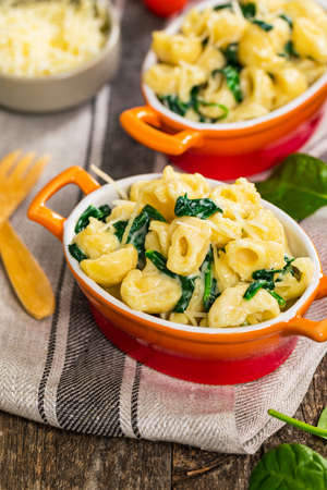 Spinach Mac and Cheese on Wooden Background. Selective focus.の写真素材
