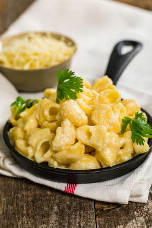 Macaroni and Cheese Old Fashioned Skillet on Wooden Background. Selective focus.の写真素材