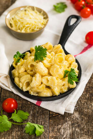 Macaroni and Cheese Old Fashioned Skillet on Wooden Background. Selective focus.の写真素材