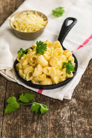 Macaroni and Cheese Old Fashioned Skillet on Wooden Background. Selective focus.の写真素材