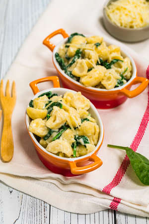 Spinach Mac and Cheese on Wooden Background. Selective focus.の写真素材