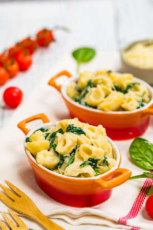Parmesan Spinach Macaroni and Cheese on Wooden Background. Selective focus.の写真素材