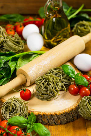 Spinach and Basil Pasta Nests on Wooden Background. Selective focus.の写真素材