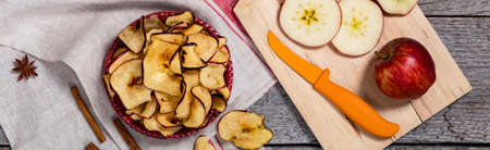 Baked Cinnamon Apple Chips. Panoramic image. Selective focus.の写真素材