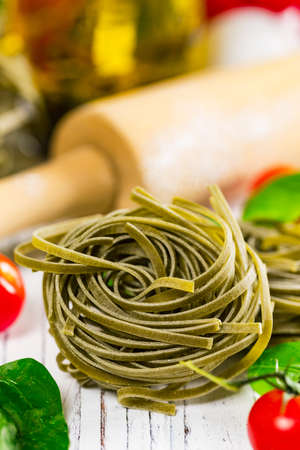 Spinach and Basil Pasta Nests Background. Selective focus.の写真素材