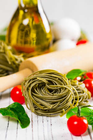 Spinach and Basil Pasta Nests Background. Selective focus.の写真素材