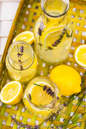 Lemonade with Lemons and Lavender. Cold Infused Detox Water with Lemon and Lavender. Provence Style. Selective focus.の写真素材