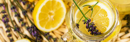 Lemonade with Lemons and Lavender. Cold Infused Detox Water with Lemon and Lavender. Provence Style. Selective focus.の写真素材