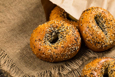 Freshly Baked Bagels Topped with Sesame Seeds, Poppyseeds, Garlic and Onion. Selective focus.の写真素材