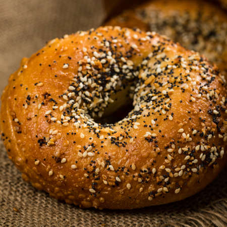 Freshly Baked Bagels Topped with Sesame Seeds, Poppyseeds, Garlic and Onion. Selective focus.の写真素材