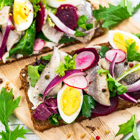 Beetroot and Pickled Marinated Herring Open Sandwich on Rye Bread. Selective focus.の写真素材