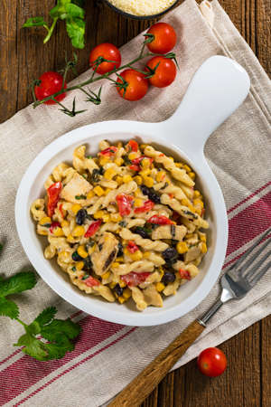 Cheesy Grilled Chicken Alfredo Pasta Florentine with Black Beans and Corn. Selective focus.の写真素材