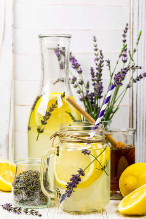 Lemonade with Lemons and Lavender. Cold Infused Detox Water with Lemon and Lavender. Provence Style. Selective focus.の写真素材