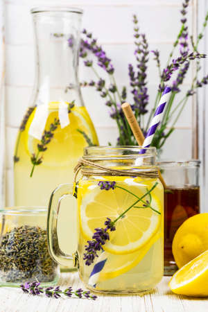 Lemonade with Lemons and Lavender. Cold Infused Detox Water with Lemon and Lavender. Provence Style. Selective focus.の写真素材