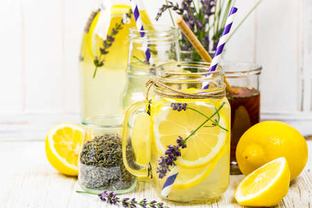 Lemonade with Lemons and Lavender. Cold Infused Detox Water with Lemon and Lavender. Provence Style. Selective focus.の写真素材