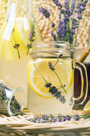 Lemonade with Lemons and Lavender. Cold Infused Detox Water with Lemon and Lavender. Provence Style. Selective focus.の写真素材