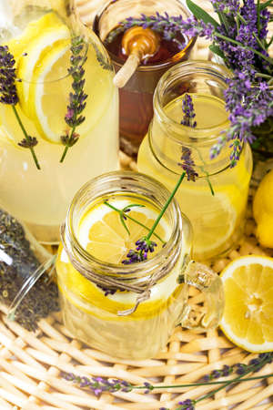 Lemonade with Lemons and Lavender. Cold Infused Detox Water with Lemon and Lavender. Provence Style. Selective focus.の写真素材